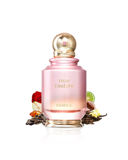 khadlaj rose couture perfume bottle surrounded with its ingredients like rose and ous with many others like pear and citrus shows from behind the bottle  against white background