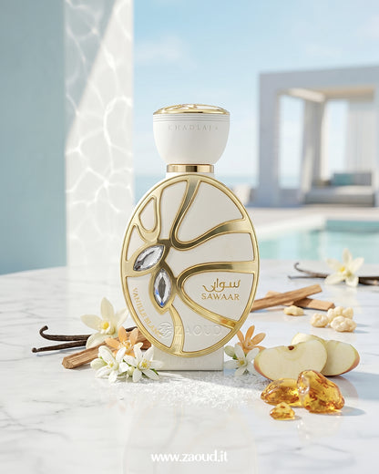 Elegant Khadlaj Sawaar Vanille Blanc perfume bottle surrounded by vanilla pods, apple slices, white florals, cinnamon, and amber resin showcasing a creamy vanilla cashmere gourmand scent.