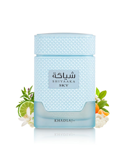 khadlaj shiyaaka sky perfume bottle surrounded with fragrance notes like flowers and citrus shows against white background