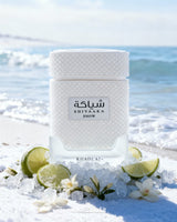 Shivaaka Snow perfume bottle on a snowy beach with ocean in the background