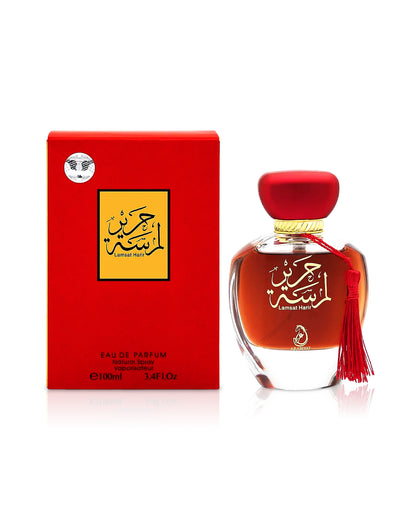 my perfumes lamsat harir Perfume bottle with red cap and tassel next to its packaging on a white background