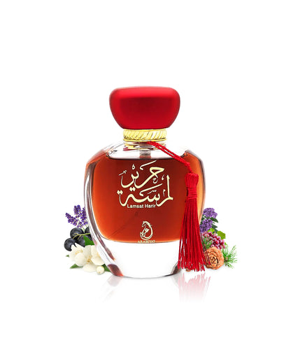 arabiyat lamsat harir perfume bottle surrounded with fragrance notes like jasmnine and grapes shows against white background