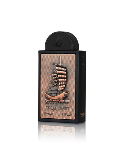 lattafa Creative Art Eau de Parfum, featuring a black rectangular box with a textured rose gold front panel depicting a detailed sailing ship, and a matching black cap on a reflective white background.