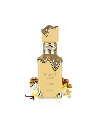 lattafa eclaire banoffi Gold and beige perfume bottle with decorative elements like banana and vanilla on a white background