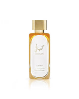 Lattafa Hayaati Gold Elixir perfume, featuring a gold cap, golden-amber liquid, and a white label with gold Arabic calligraphy and text, set against a clean white background with a soft reflection below.