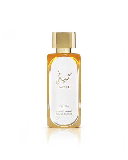 Lattafa Hayaati Gold Elixir perfume, featuring a gold cap, golden-amber liquid, and a white label with gold Arabic calligraphy and text, set against a clean white background with a soft reflection below.