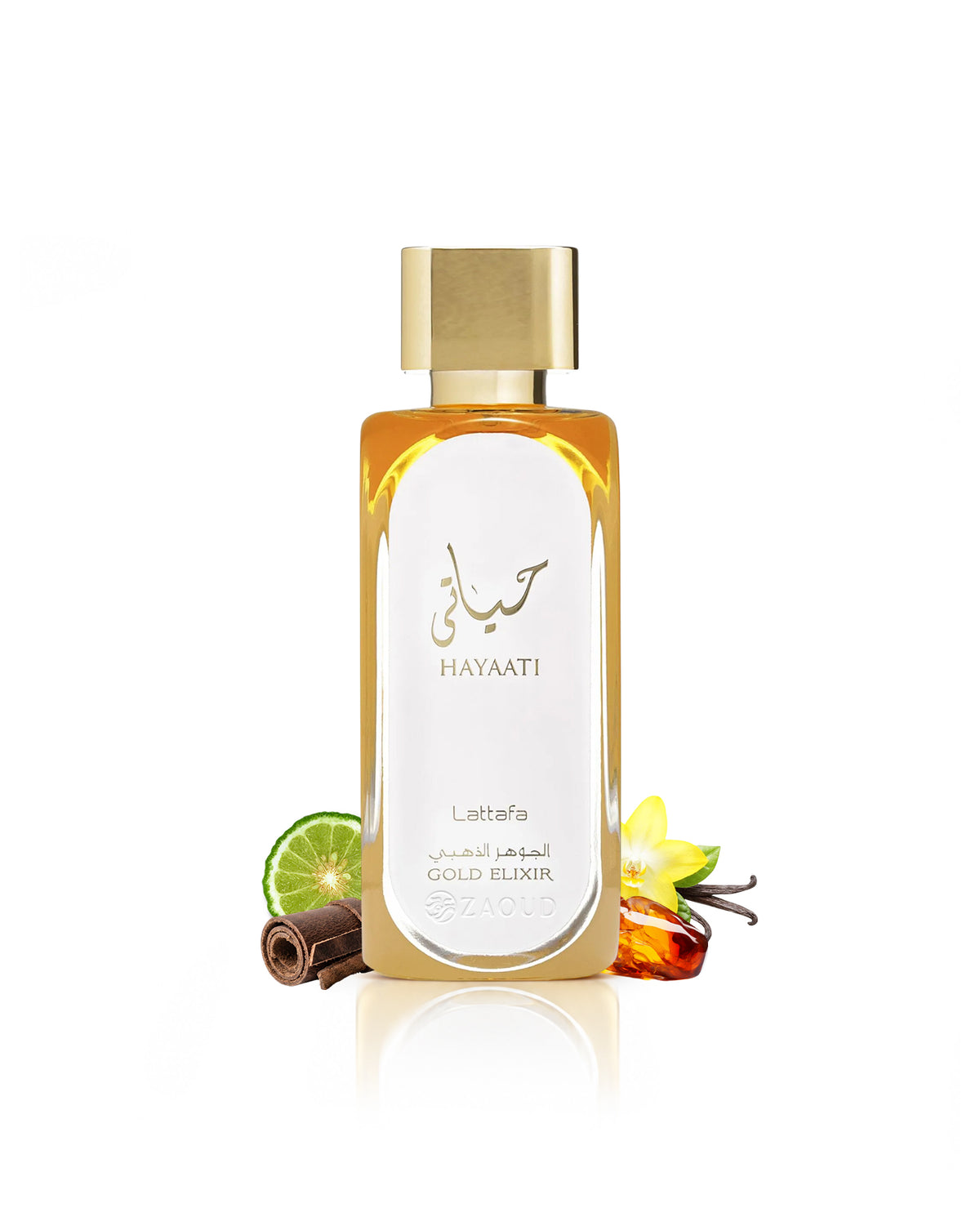 Lattafa Hayaati Gold Elixir with a gold cap and white label, surrounded by decorative ingredients including a lime slice, cinnamon stick, vanilla flower, and amber liquid, on a white background with a soft reflection.