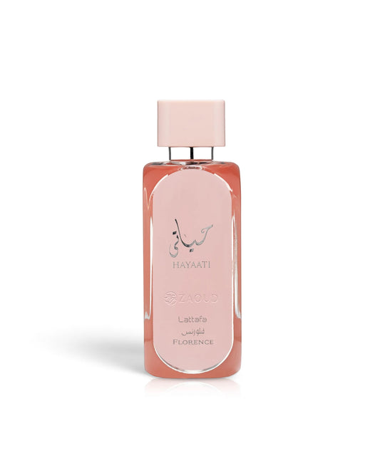 A rectangular glass perfume bottle with a pale pink cap and a peachy-pink liquid inside, featuring the HAYAATI florence by lattafa, set against a plain white background.