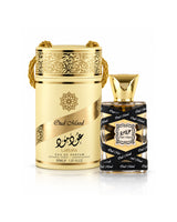 lattafa oud mood miniature perfume shown with a gold cylindrical box and a rectangular glass bottle with a black-and-gold patterned label, on a white background.