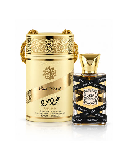 lattafa oud mood miniature perfume shown with a gold cylindrical box and a rectangular glass bottle with a black-and-gold patterned label, on a white background.