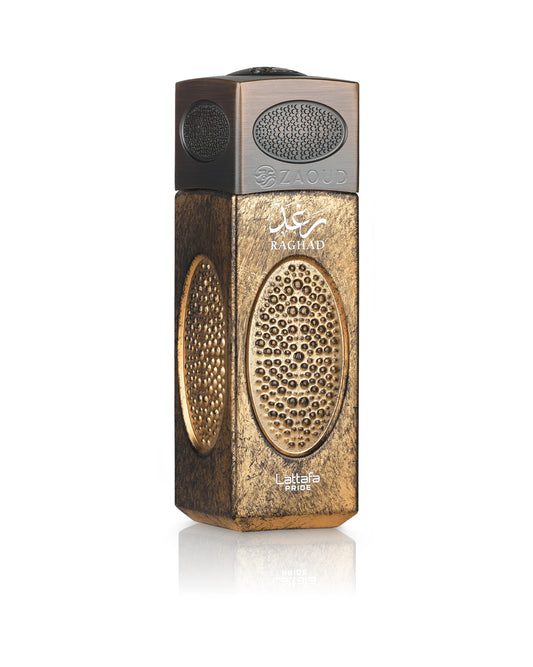 A metallic gold and bronze rectangular perfume atomizer bottle with intricate circular perforated patterns, featuring the brand name 'raghad' on the front, set against a plain white background with a soft reflection below.