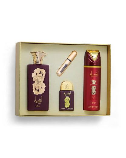 Lattafa ansaam gold gift Set including a bottle, a perfume automizer, and a box in a gold box on a white background