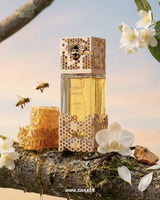lattafa-atheeri Perfume bottle with honeycomb design on a natural background with flowers and bees.