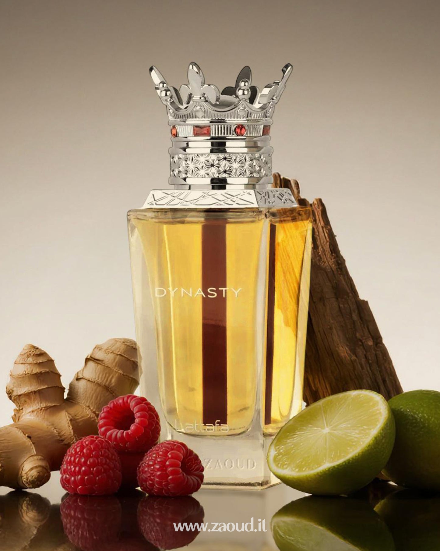 Lattafa Dynasty perfume bottle with a regal silver crown cap, placed among fresh raspberries, sliced bergamot, ginger root, and a piece of cedarwood.