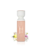 lattafa fakhar rose body mist Bottle with a white top and pink bottom on a white background with flowers at the base.