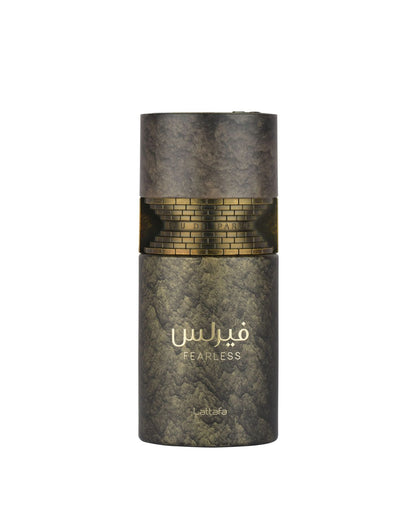 A cylindrical perfume bottle with a textured dark metallic finish, featuring a gold brick-patterned band around the middle and gold Arabic lettering that reads 'FEARLESS' with 'lattafa' below, set against a plain white background.