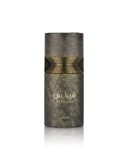A cylindrical perfume bottle from the brand lattafa, named Fearless, featuring a textured dark gray and gold marble-like design with a gold brick pattern band around the middle and gold Arabic lettering.