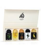 lattafa pride box miniature, showing five small perfume bottles arranged in a cream-colored presentation box. The bottles have black and gold caps and feature different illustrated labels including a green snake, a yellow bee, a gold pocket watch, a black tree, and a yellow bird.
