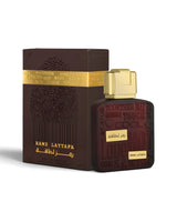 lattafa ramz gold perfume bottle shows beside its packaging against white background