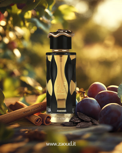 lattafa teriaq intense perfume bottle outdoor photograph beside plum tonka beans and cinnamon against warm sunset