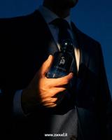 Person holding a black bottle labeled 'Champion' against a dark background
