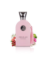 A pink perfume bottle labeled DELILAH POUR femme, featuring a silver cap, a pink tassel, and decorative fruit and flower props on a white background.