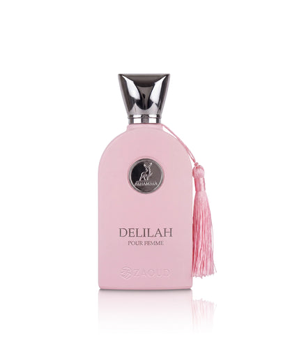 A pink perfume bottle with a silver cap and a pink tassel, labeled 'DELILAH POUR FEMME', on a white background.