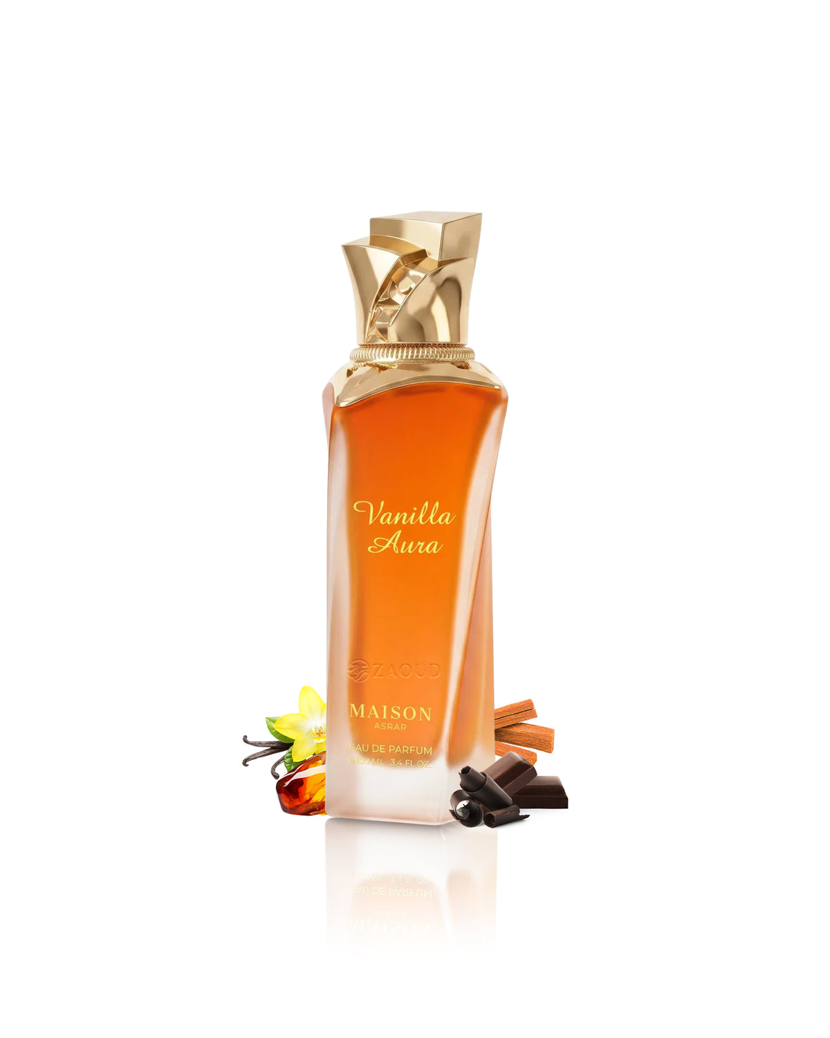 Maison asrar Vanilla Aura Parfum bottle with amber liquid and a gold cap, styled with vanilla flowers, cinnamon sticks, and chocolate pieces on a white background.