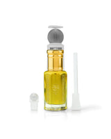 marj perfume oil bottle filled with golden yellow liquid, featuring a ribbed gray and white pump cap, shown with a white applicator wand and a small white cap on a clean white background.
