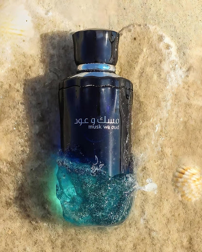 musk wa oud by khadlaj perfume bottle photograph under water at beach beside a sea shell over sands