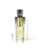 nazar perfume oil bottle with a shiny gold neck and a textured black cap, shown on a white background with its cap off and a white applicator wand beside it.