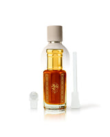 outcast perfume bottle with golden cap shows outlands bottle behind against white background