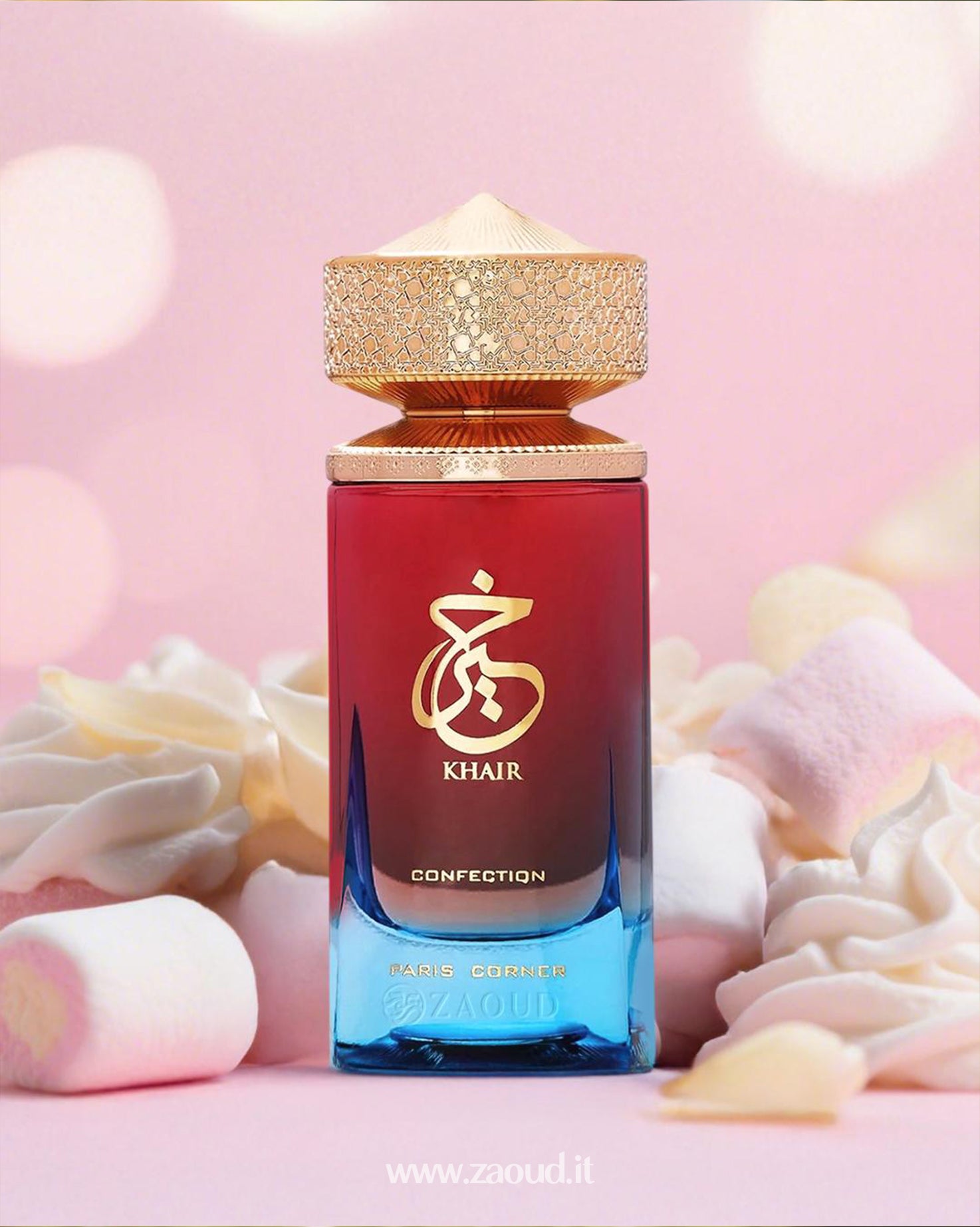 Paris Corner Khair Confection perfume bottle from Paris Corner, featuring a red-to-blue gradient design with gold detailing, surrounded by soft marshmallows and set against a pink background