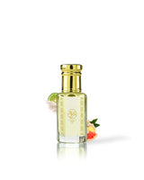 pomela perfume oil bottle with a shiny gold cap and gold decorative patterns, filled with pale yellow liquid. The bottle is centered on a white background with a soft reflection, decorated with a lime wedge, white flower, and citrus slice.