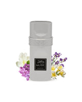 pure musk edp perfume BOTTLE surrounded by fressia iris against white background