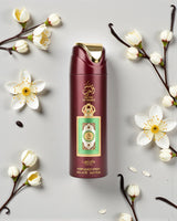 lattafa queen of arabia deodorant bottle with floral elements on a light gray background