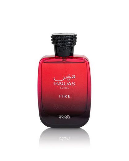 A bottle of hawas Fire For Him cologne, featuring a red gradient glass bottle with a black cap, shown on a white background with a soft reflection.