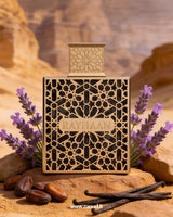 Perfume bottle labeled 'Rayhaan' with lavender flowers and vanilla beans on a desert background