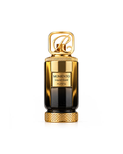 Riiffs momento liquid gold perfume bottle featuring a glossy gold and black cylindrical body with a decorative gold cap and base, set against a solid white background.