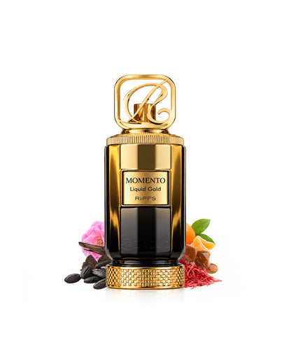 Riiffs momento liquid gold perfume bottle in a glossy gold and black finish, styled with botanical and spice ingredients on a clean white background.