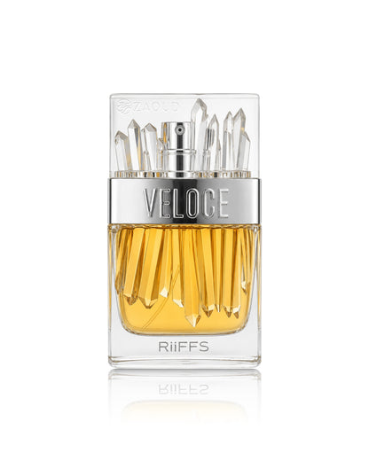 A bottle of Riiff's Veloce fragrance with a clear glass body, golden-yellow liquid, a silver metallic band with the brand name 'VELOCE', and clear faceted crystal-like sprigs at the top, set against a plain white background with a soft reflection below.