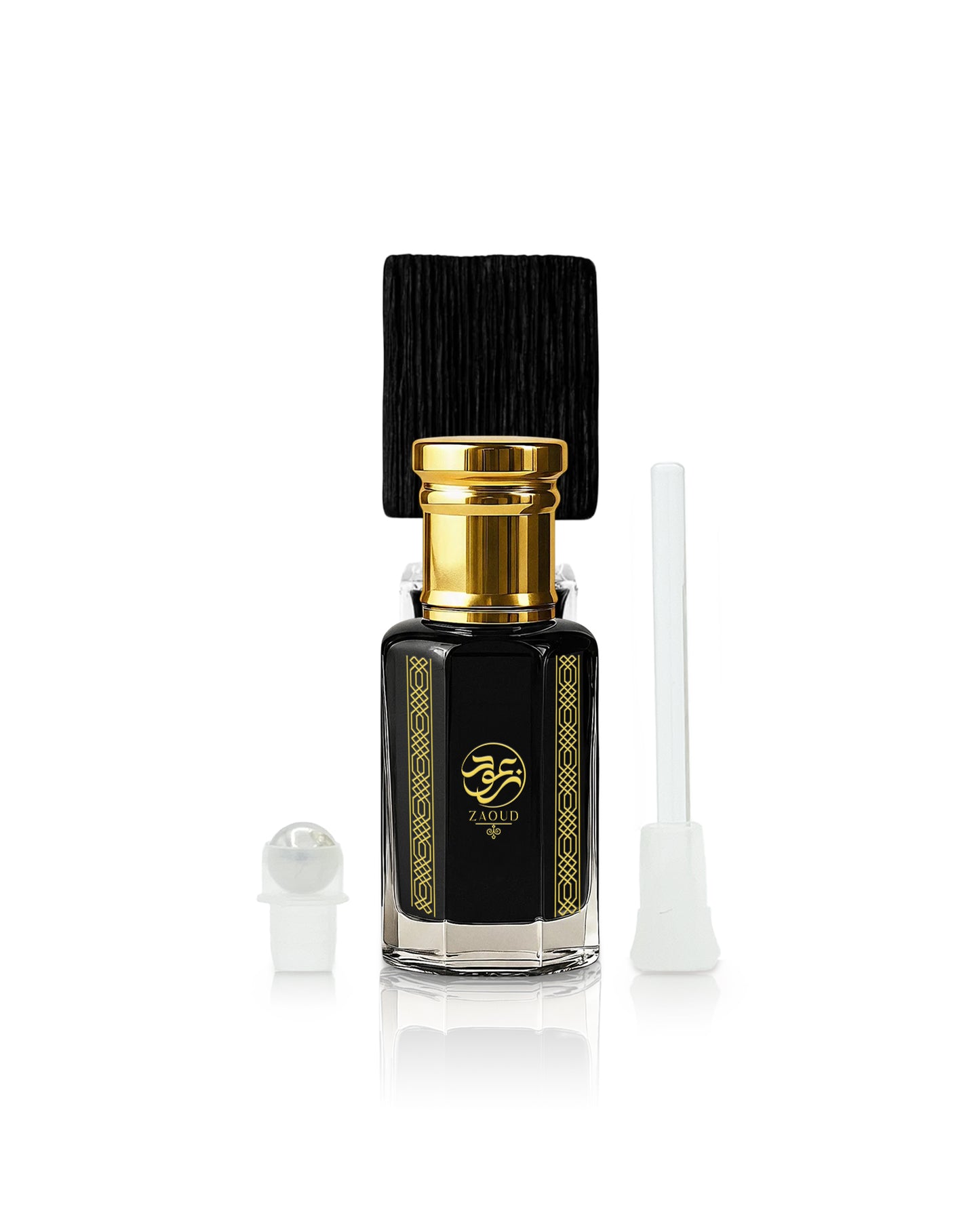 A black glass sabbah perfume oil bottle with a gold cap and gold decorative borders, shown with a black cap, a white dropper, and a white applicator on a white background.