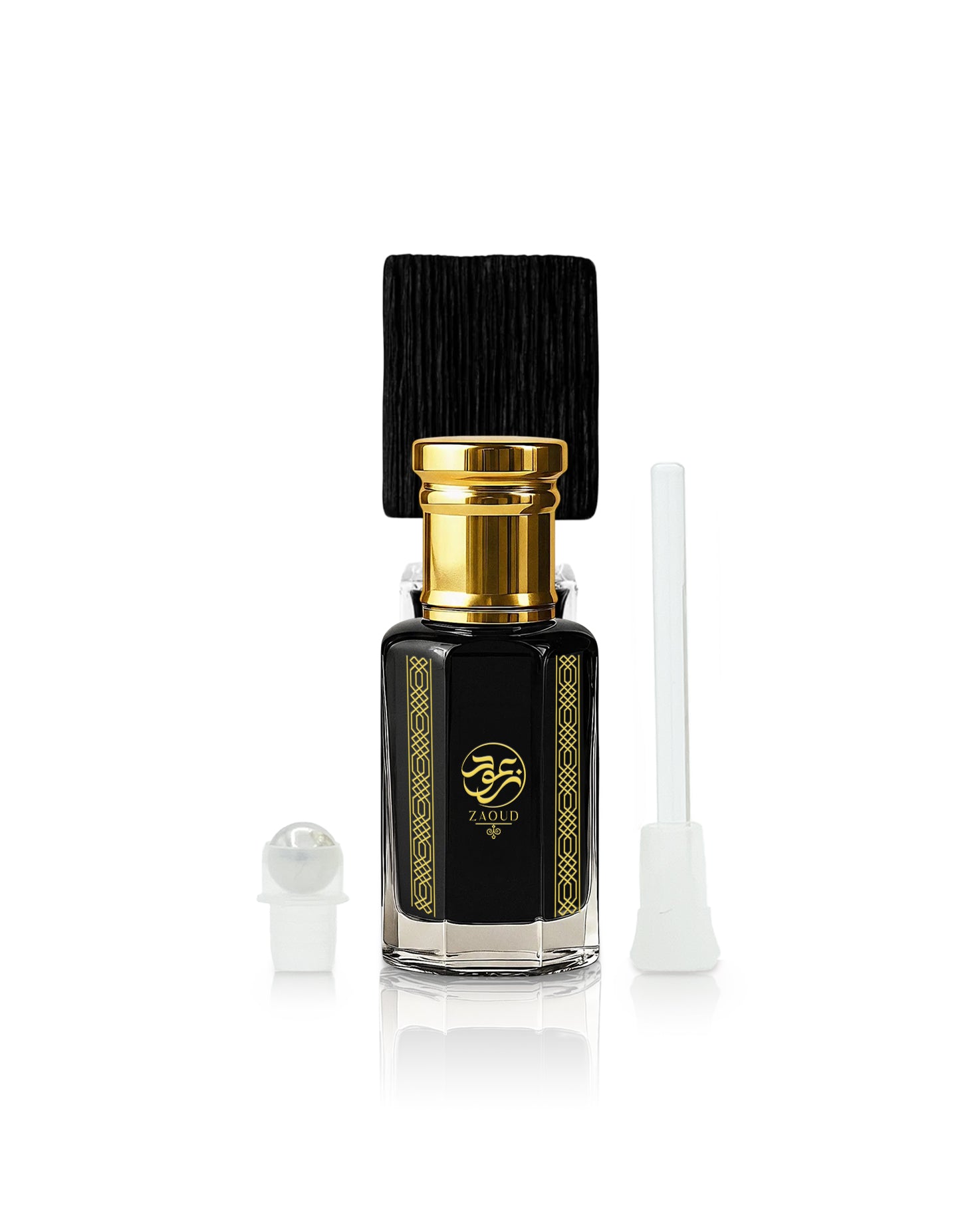A black glass sabbah perfume oil bottle with a gold cap and gold decorative borders, shown with a black cap, a white dropper, and a white applicator on a white background.