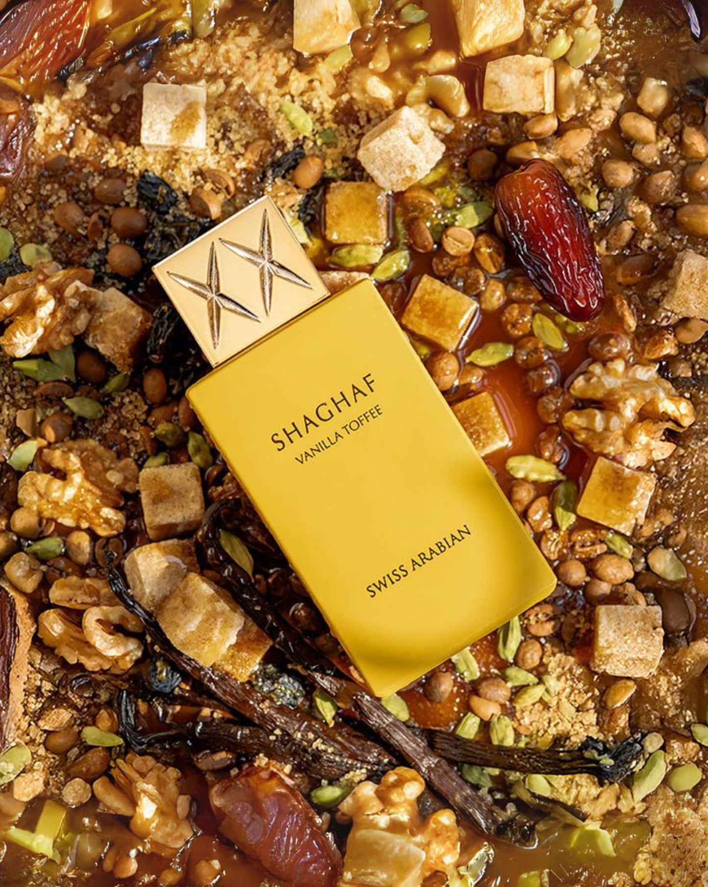 swiss arabian shaghaf vanilla toffee perfume bottle placed on a luxurious blend of creamy sweets, dates, nuts, and exotic spices, evoking rich Arabian fragrance notes with hints of vanilla and toffee.