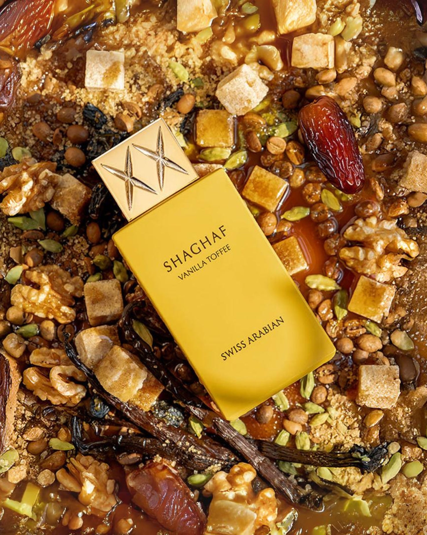 swiss arabian shaghaf vanilla toffee perfume bottle placed on a luxurious blend of creamy sweets, dates, nuts, and exotic spices, evoking rich Arabian fragrance notes with hints of vanilla and toffee.