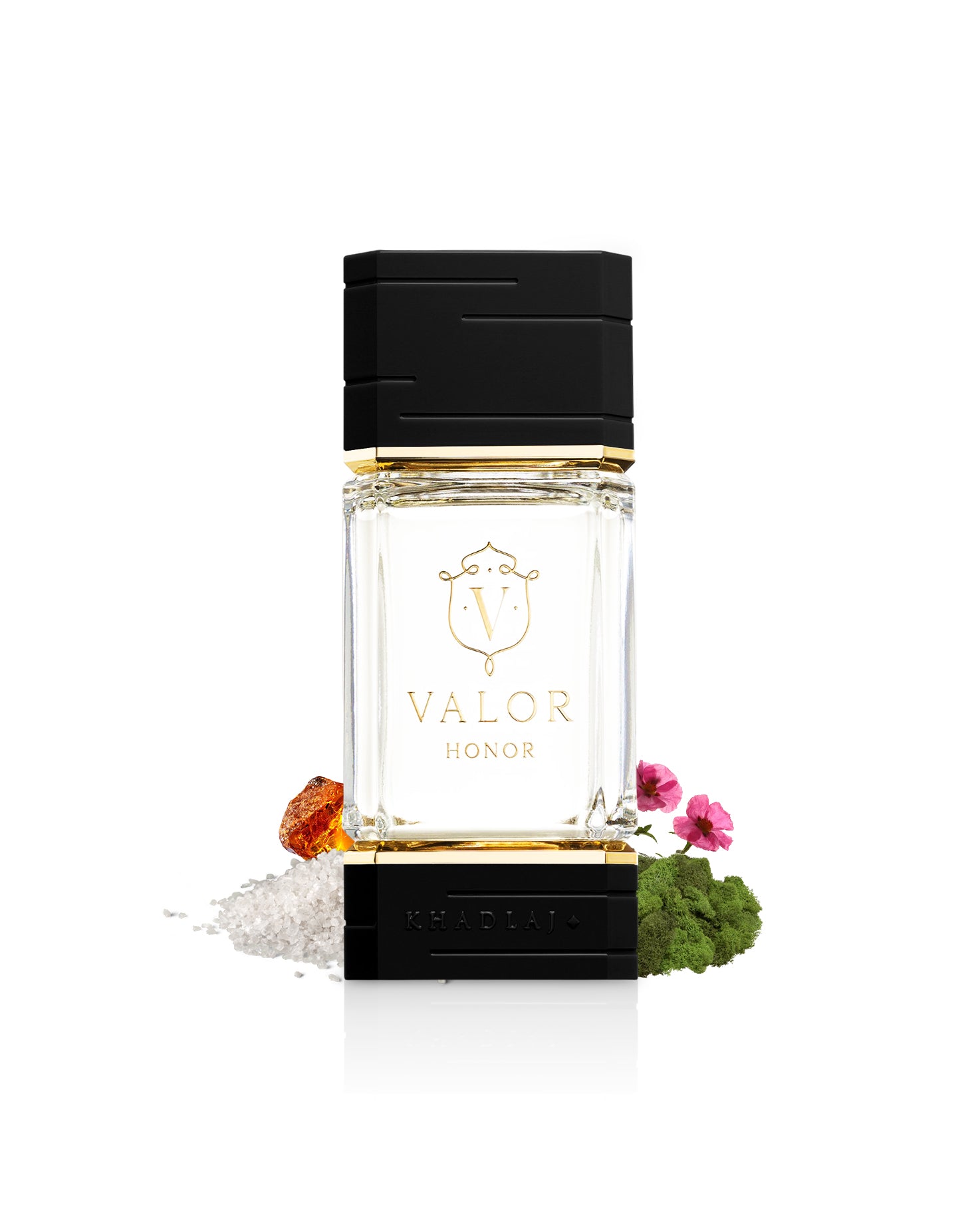 khadlaj valor honor perfume bottle surrounded with its ingredients like salt and amber shows from behind the bottle  against white background