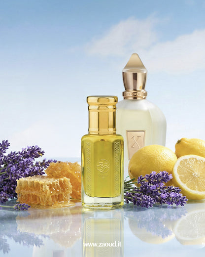 xenia-noble-perfume-oil products with lemons, lavender, and honeycomb on a reflective surface.