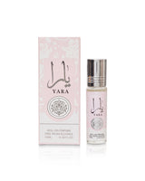 Yara roll-on perfume shown with its light pink packaging box and a clear glass spray bottle with a silver cap on a white background.