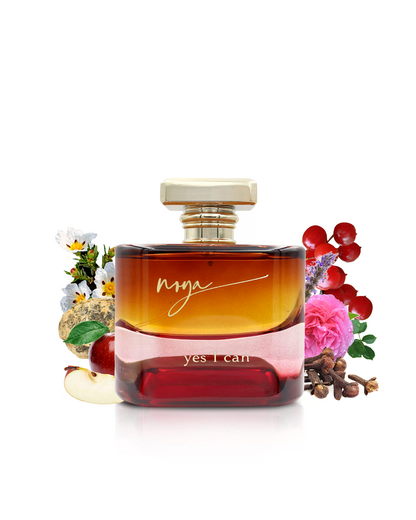 yes i can by maison de noya perfume bottle surrounded with its ingredients like cloves and apple with many others shows from behind the bottle against white background