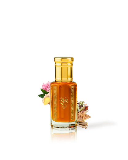zaoud perfume oil bottle topped with a shiny gold cap, centered on a white background with small decorative flowers and dried botanicals beside it.